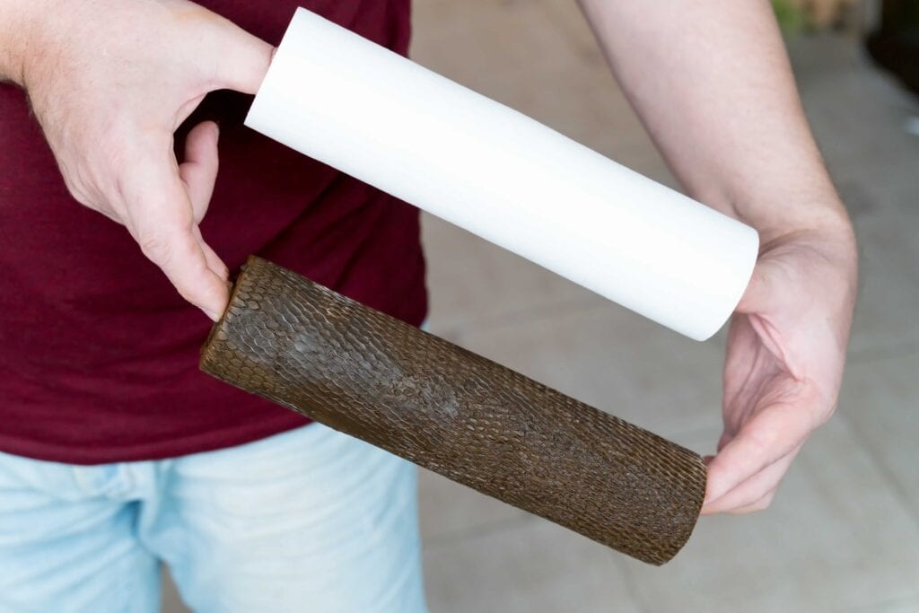 Side-by-side comparison of a person holding a brand new white sediment water filter cartridge next to a heavily used, dark brown, sludge-covered filter.