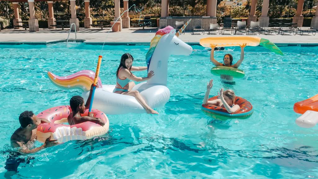 Family Enjoying A Clean Backyard Pool In Belleview Florida